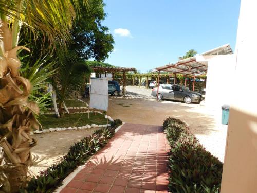 a brick walkway in front of a parking lot at Hotel El Perico Marinero in Río Lagartos