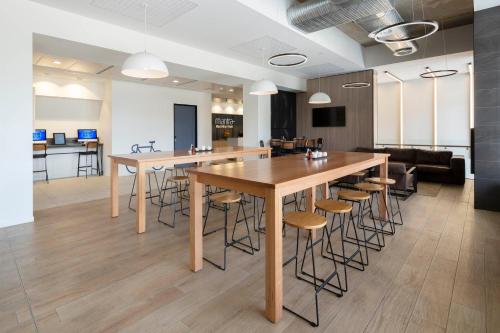 an office with tables and stools in a room at Mantra MacArthur Hotel in Canberra