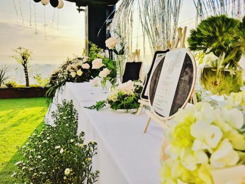 a table with flowers and a sign on it at Holiday One Can Tho Hotel in Can Tho