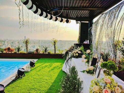 a wedding venue with a table with flowers and a view at Holiday One Can Tho Hotel in Can Tho