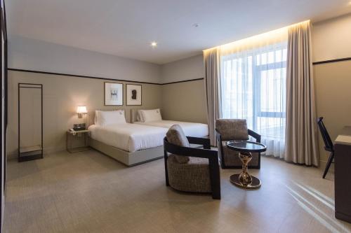 a hotel room with a bed and a window at Browndot Business Seomyeon in Busan