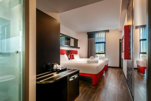 a hotel room with a bed and a bathroom at Essence Hotel Carlton in Melbourne