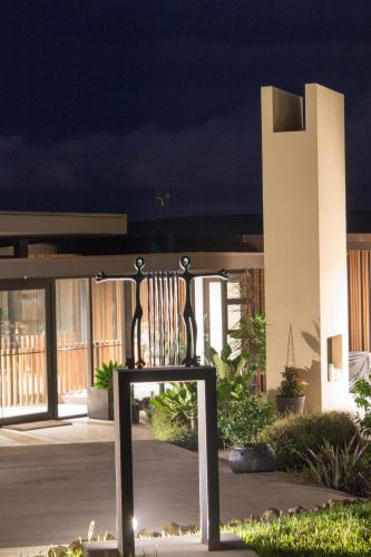 a bench in front of a building at night at La Bodega Waiheke Island in Surfdale