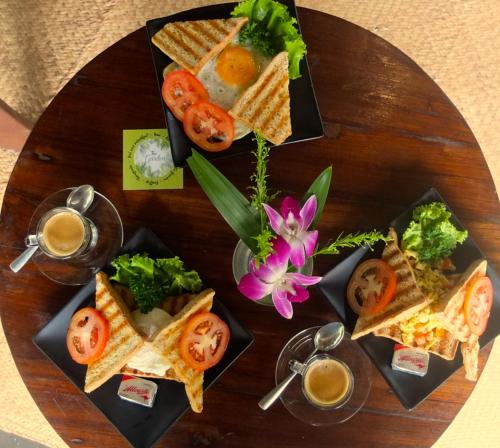 a wooden table topped with different types of food at The Garden in Thong Sala