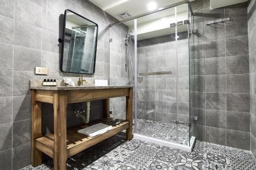a bathroom with a sink and a shower at 翠安儂風旅 in Taitung City