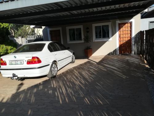a white car parked in front of a house at The Hancock Inn in Klerksdorp