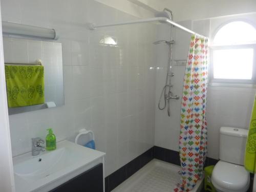ein Bad mit einem Waschbecken und einem Duschvorhang in der Unterkunft Diamond Complex in Paphos City