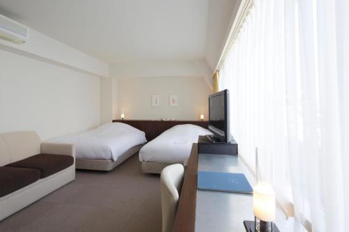 Posteľ alebo postele v izbe v ubytovaní Hotel Garden Square Shizuoka