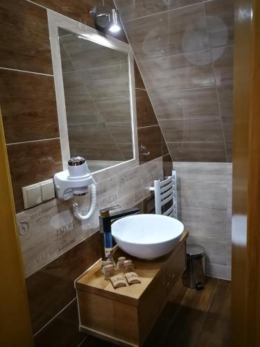 a bathroom with a sink and a mirror at Domek u Kubusia in Białka Tatrzańska
