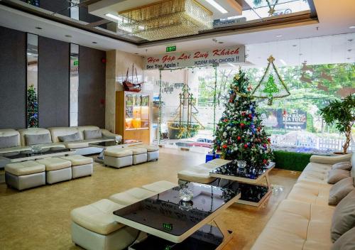 a living room with a christmas tree in the middle at Dendro beachfront Hotel in Nha Trang