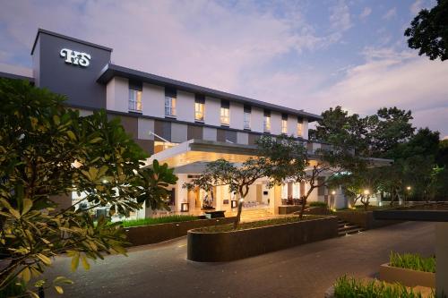 an exterior view of a building with lights at Hotel Santika Mataram in Mataram