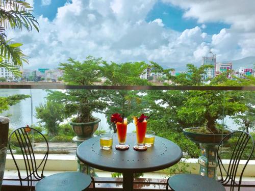 a table with two drinks on a balcony at Lake View Hotel in Quy Nhon