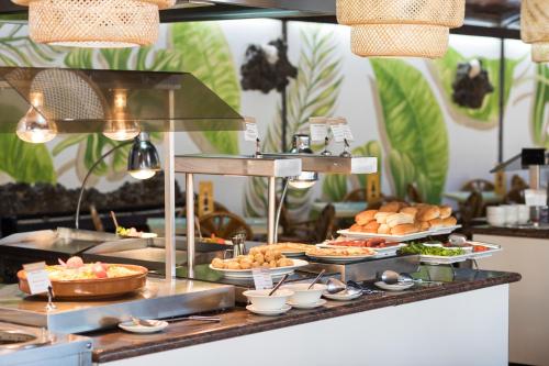 a buffet with various food items on a table at Hotel Arena Suite - Adults Only in Corralejo