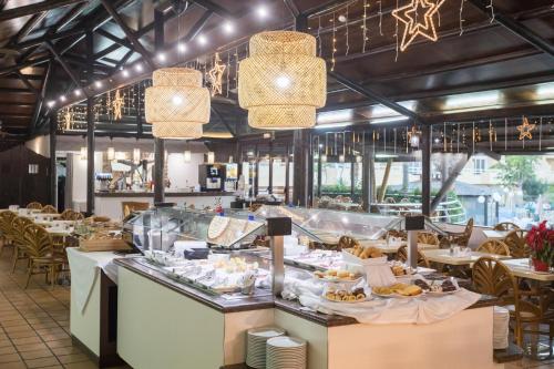 a restaurant with a buffet line with food at Hotel Arena Suite - Adults Only in Corralejo