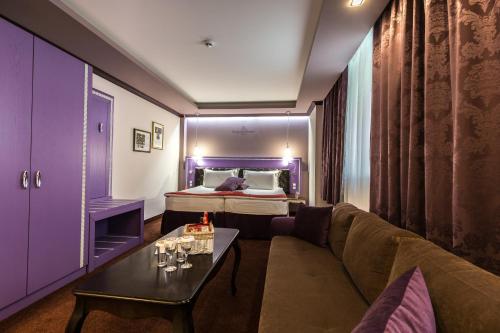 a living room with a couch and a bed at Diplomat Plaza Hotel & Resort in Lukovit