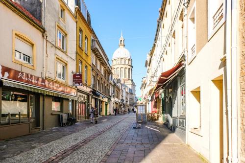 a city street with a clock tower in the background at Evancy La Marina Boulogne-sur-Mer in Boulogne-sur-Mer