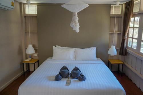 a pair of shoes sitting on a bed at HIP Seaview Resort @ Phi Phi in Phi Phi Don