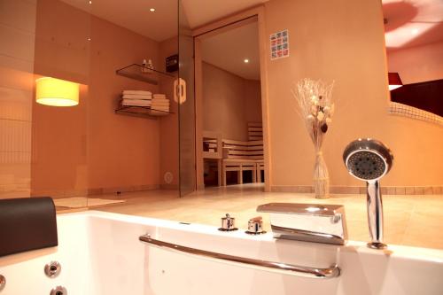 a bathroom with a sink and a mirror at Wellness-Keller in Bautzen