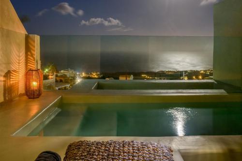 a swimming pool with a view of the water at Divelia East in Imerovigli