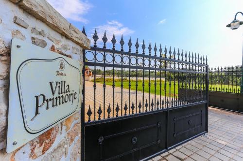 a sign for a villa pruning sign next to a fence at Villa Primorje in Biograd na Moru