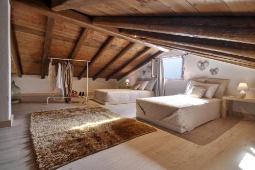 a bedroom with two beds and a rug at Villa Larna Corfu in Kavvadádes