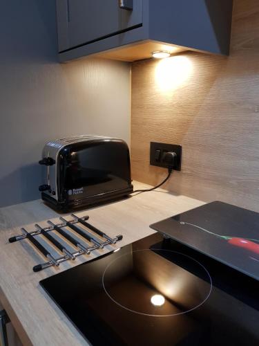 a toaster sitting on top of a kitchen counter at Smart & Cozy Holiday Apartment in the city centre in Inverness