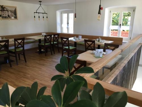 a dining room with wooden tables and chairs at Hotel im Sonnental in Jachenau