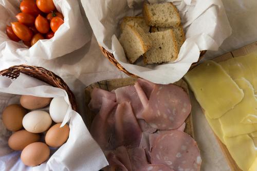 a table with eggs and bread and other foods at Agriturismo Montagna Verde Apella in Licciana Nardi