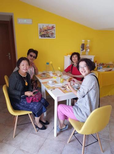 a group of people sitting around a table at B&B Dimora del centro in Scalea