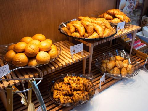 a display of bread and pastries on display in a bakery at Super Hotel Yamagata Sakurambo-Higashine Station Front in Higashine