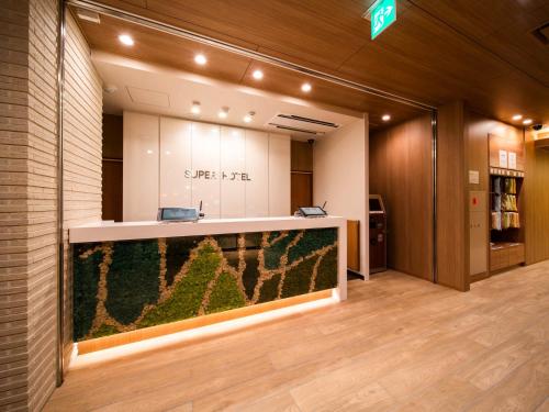 an office with a large aquarium in the middle of a room at Super Hotel Yamagata Sakurambo-Higashine Station Front in Higashine