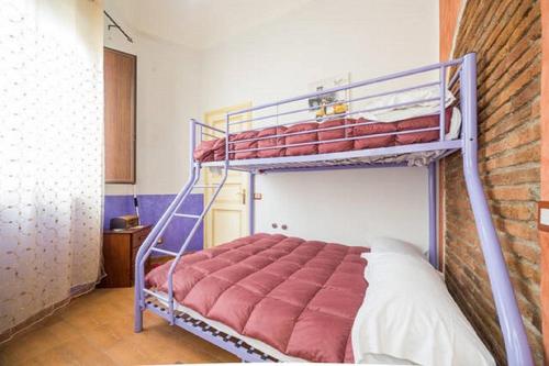 a bedroom with a bunk bed and a brick wall at Bellavista in Acireale