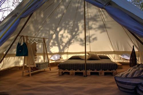 a bedroom with a bed in a tent at Shauri Glamping in Noto