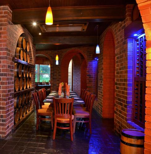 a dining room with a long table and chairs at BON Hotel Empangeni in Empangeni