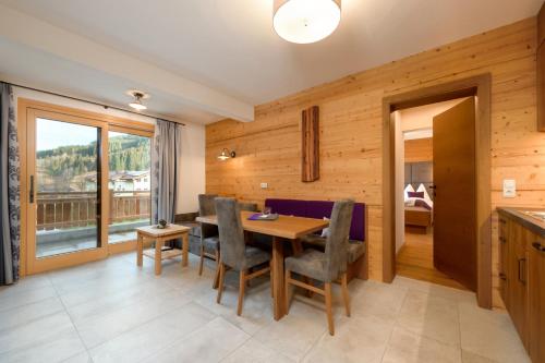 a kitchen and dining room with a table and chairs at Stockhambauer in Kleinarl