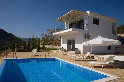 a villa with a swimming pool and a house at Dream View Villas in Sivota