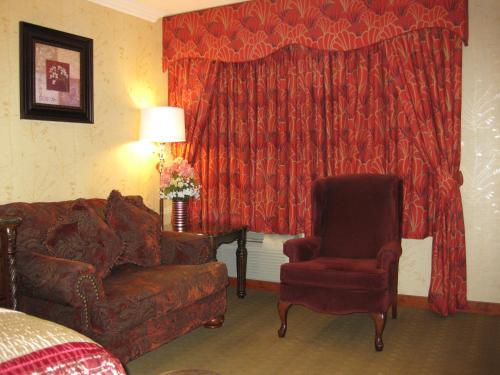 a living room with a couch and a chair at Acorn Motor Inn in Oak Harbor