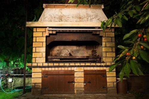 an outdoor brick oven with a door in a yard at Apartments Kolevski in Ohrid