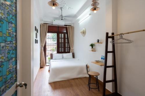 a bedroom with a bed and a ladder at Nusmile's Hostel and Travel in Hanoi