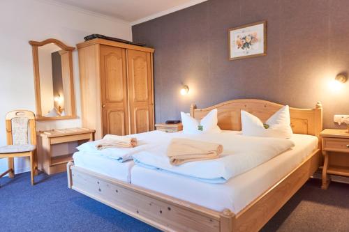 a bedroom with a large bed with white sheets and pillows at Haus Strandeck in Zingst