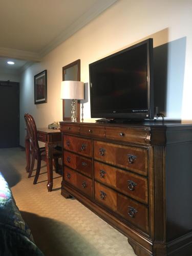 a living room with a television on a dresser at Acorn Motor Inn in Oak Harbor
