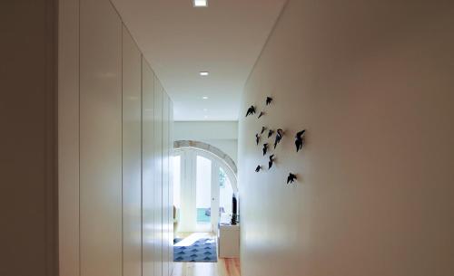 a hallway with a wall with bats on the wall at HM - The Garden in Porto