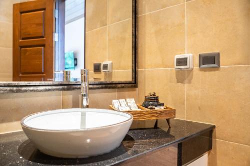 a bathroom with a large white bowl sink on a counter at Phor Liang Meun Terracotta Arts in Chiang Mai