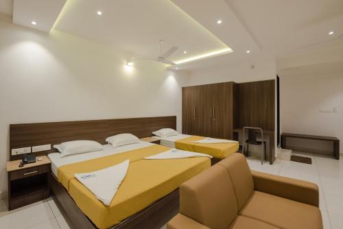 A bed or beds in a room at Hotel Karuna Residency