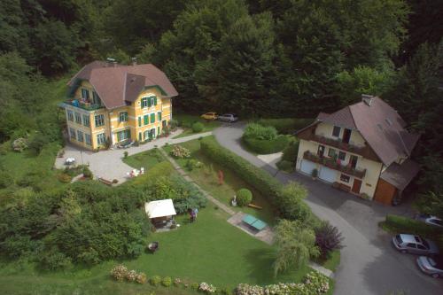 eine Luftansicht eines großen Hauses mit Hof in der Unterkunft Pension Seevilla Annelies in Maria Wörth