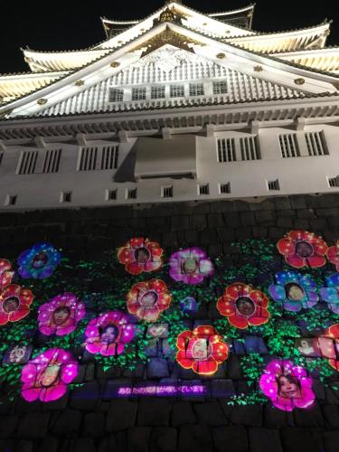 a building with a display of flowers on the ground at Family house (private house) in Osaka