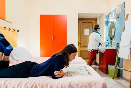 a woman laying on a bed in a room at The Beehive in Rome