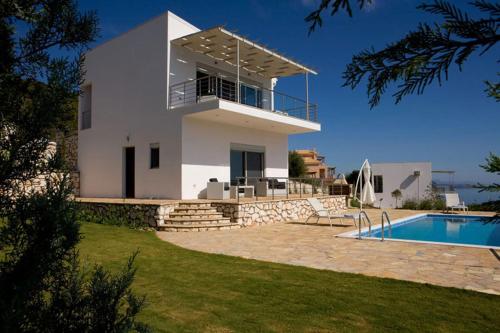 a villa with a swimming pool and a house at Dream View Villas in Sivota