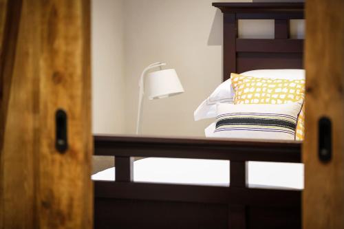 a bunk bed with a lamp and pillows on it at Gileston Manor-Self catering in Saint Athan