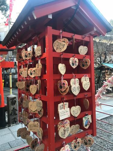 a red rack with lots of heart clocks on it at Family house (private house) in Osaka